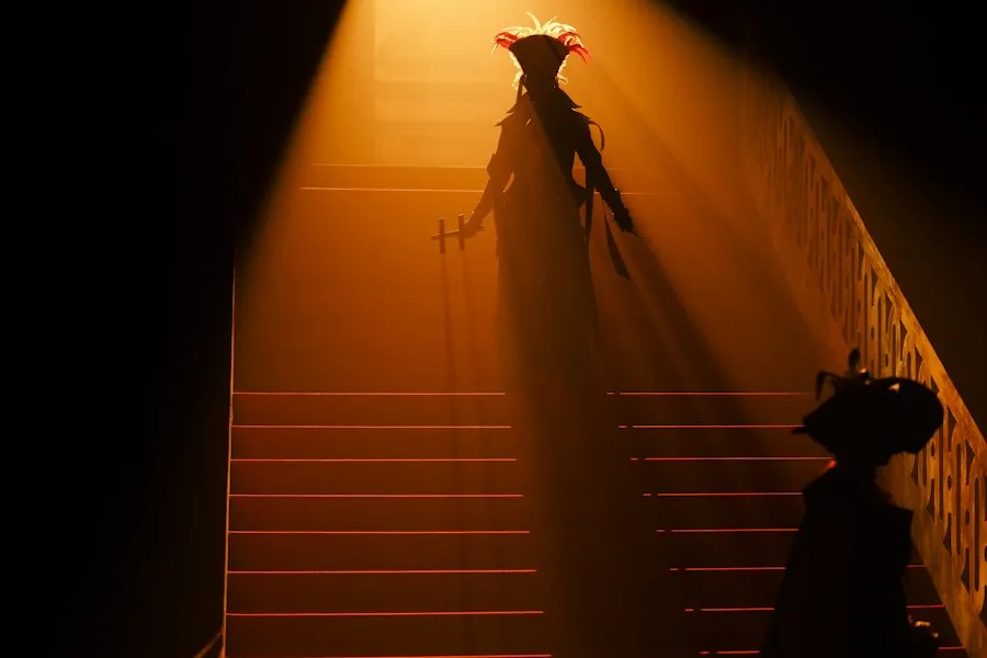 A figure on a lit stair
