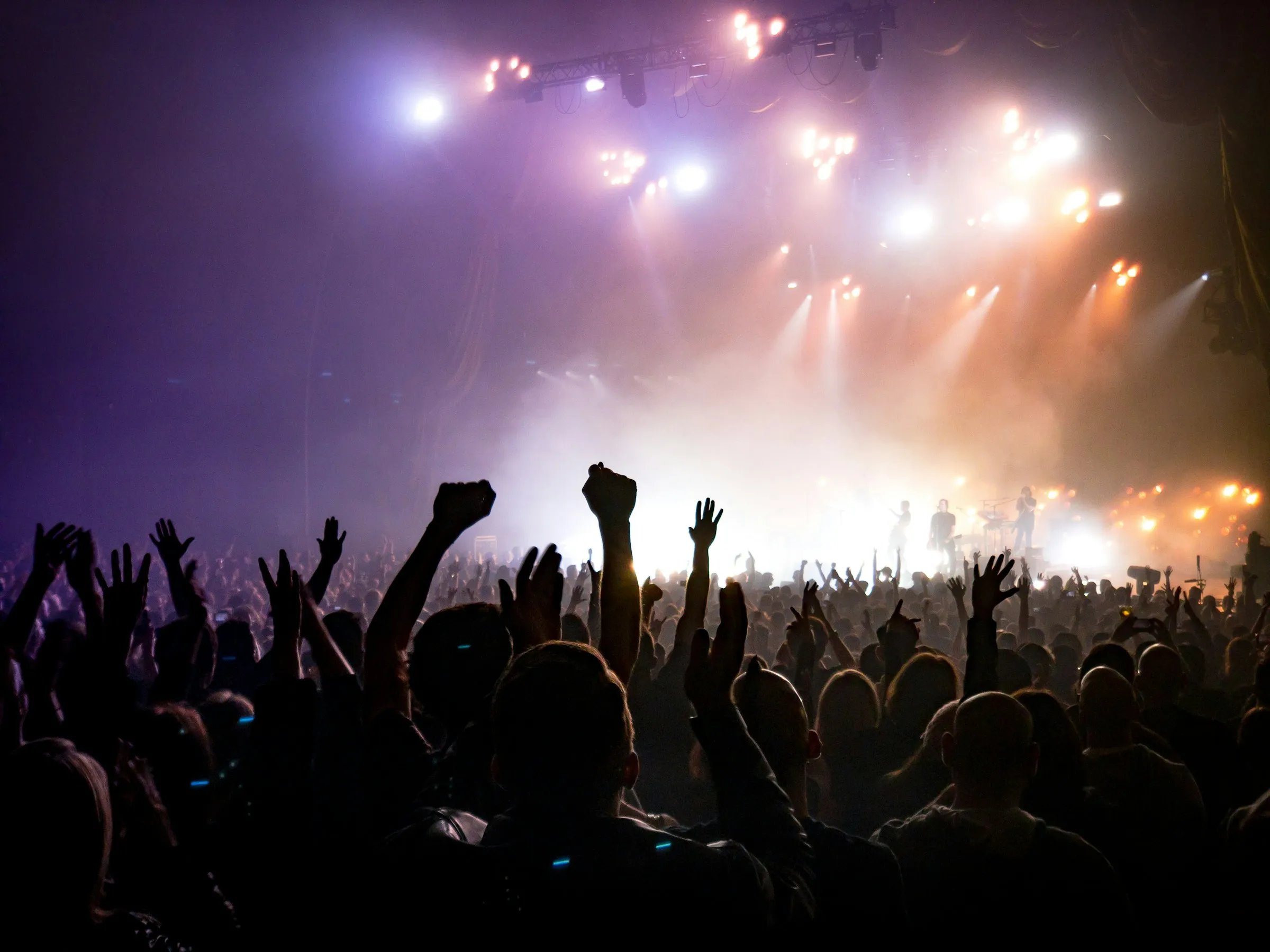 An audience facing a lit stage